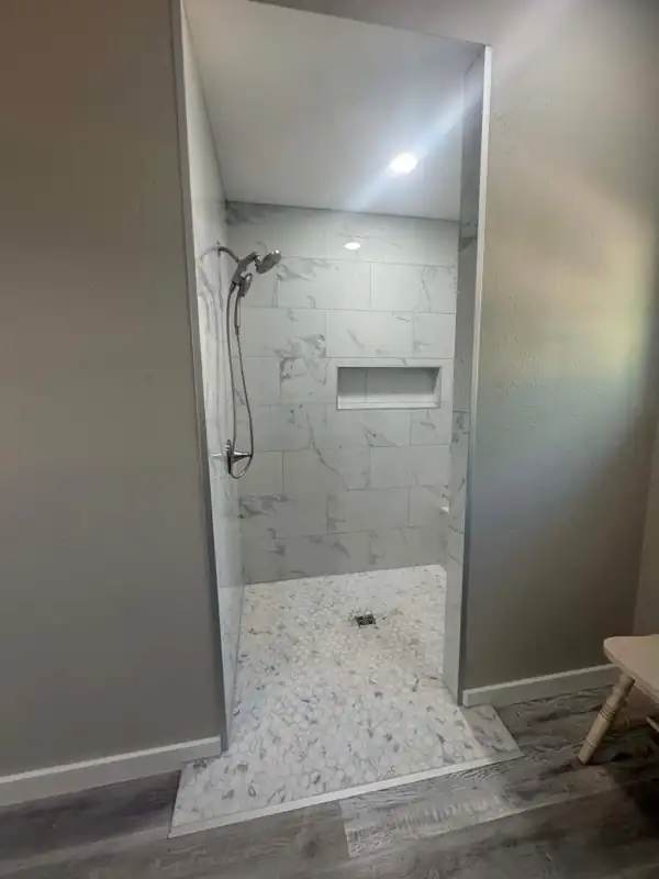 New walk-in tile shower with marble-look tile